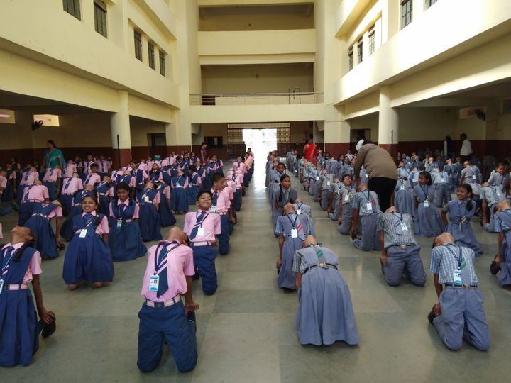 Students in prayer in the school hall