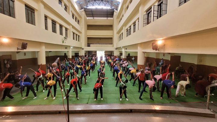 Students practising yoga in the school hall